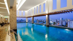 A large indoor swimming pool with clear blue water, a city view, and a modern architectural design. - Muong Thanh Grand Sai Gon Centre Hotel (Ho Chi Minh City)
