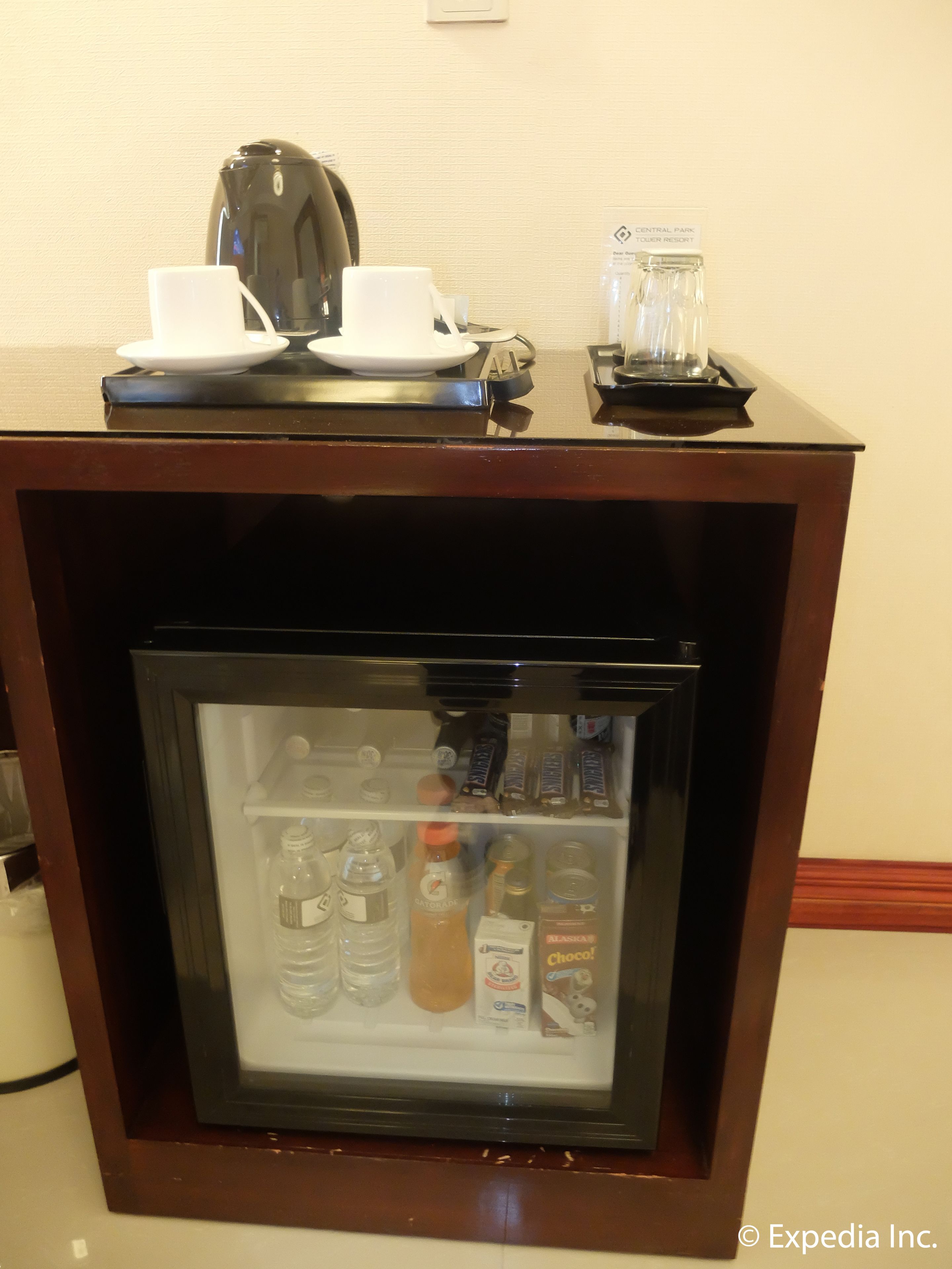 A minibar with a selection of beverages and snacks.