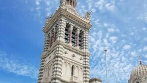 A tall, ornate building with a golden spire and classical architectural details. - Hôtel Victory (Marseille)