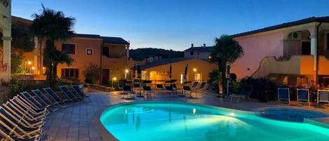 Seasonal outdoor pool, open 9:00 AM to 8:00 PM, pool umbrellas