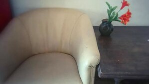 A beige armchair with a dark wooden side table beside it. - Ben Yehuda Hotel (Tel Aviv)