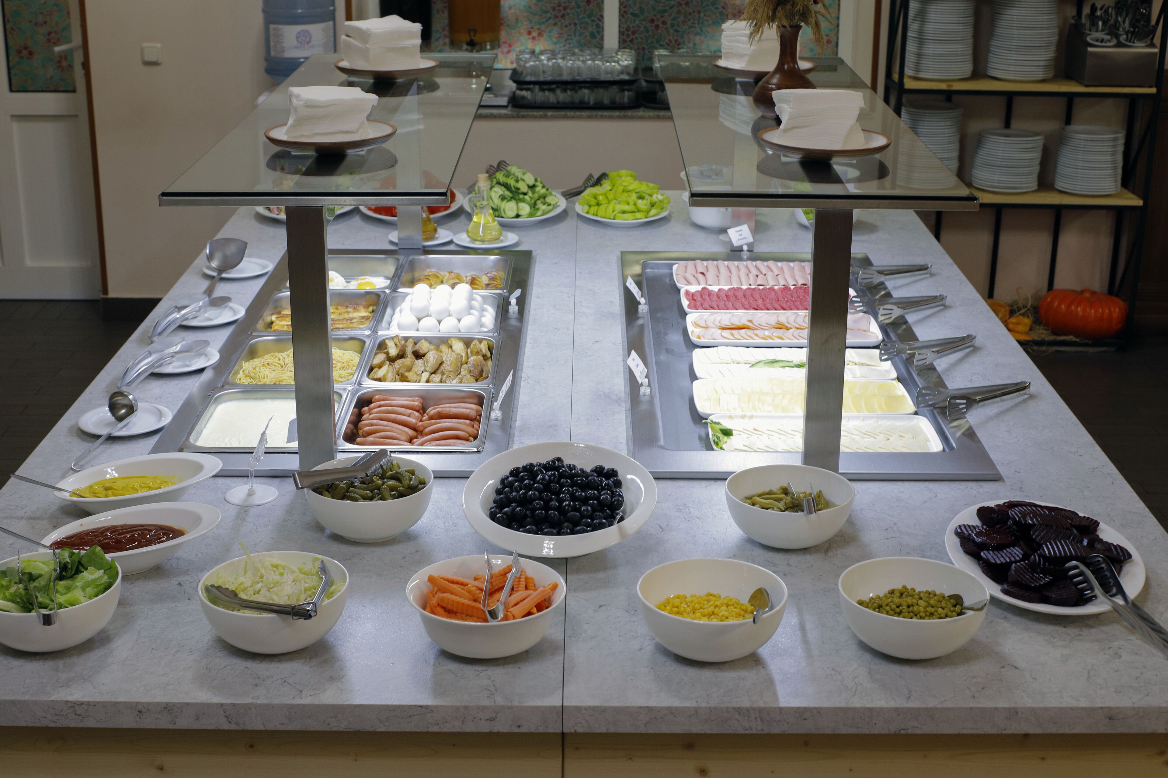 Un bufé con diferentes alimentos y utensilios.