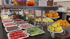 A buffet with various food items including meats, cheeses, fruits, and vegetables. - Ani Central Inn (Yerevan)