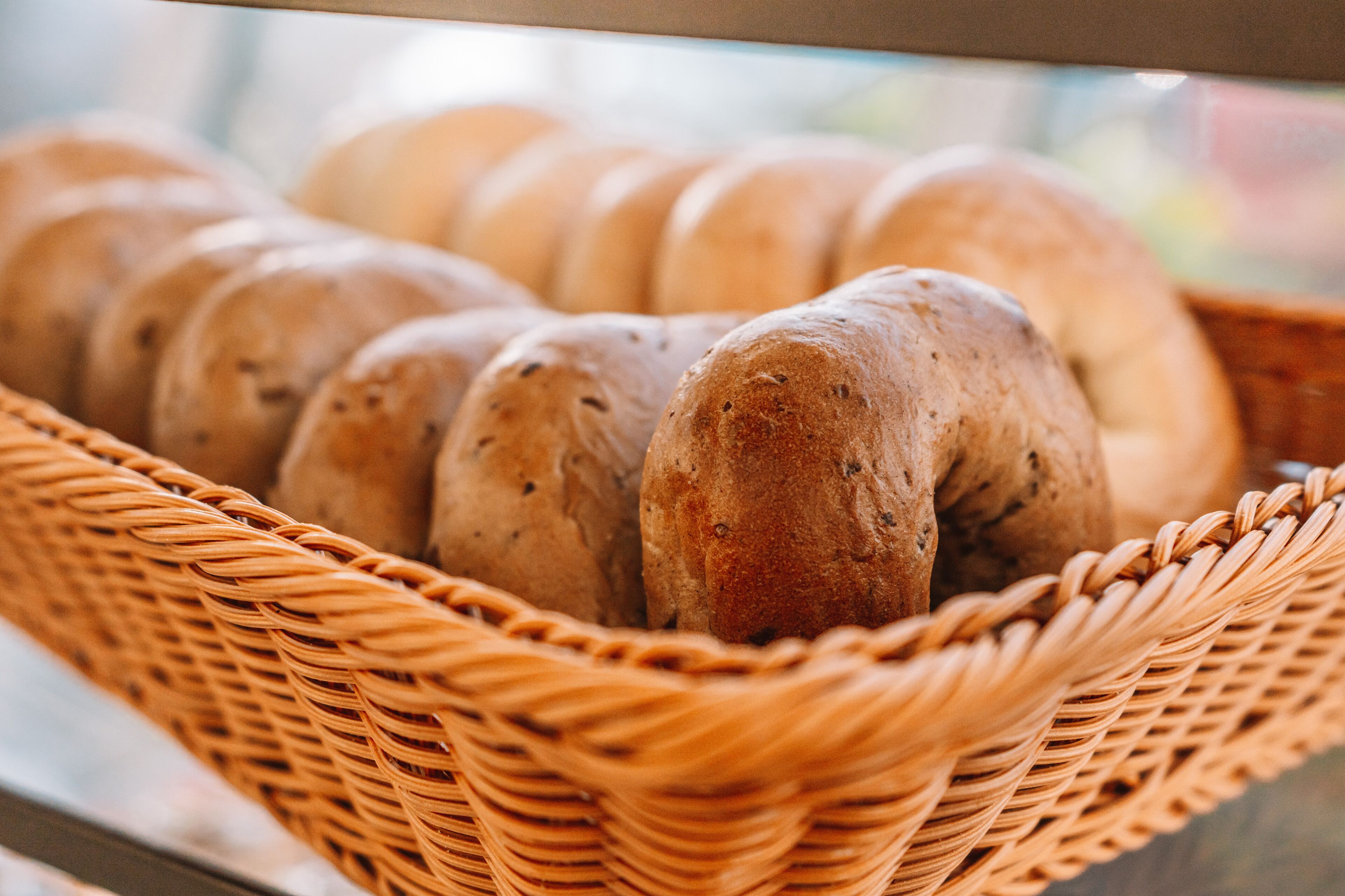 A wicker basket containing several loaves of bread.