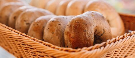 A wicker basket containing several loaves of bread.