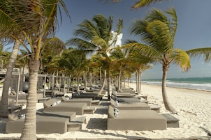 On the beach, white sand, free beach cabanas, beach towels