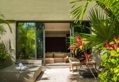 A modern outdoor living area with a sofa, chairs, and a coffee table.