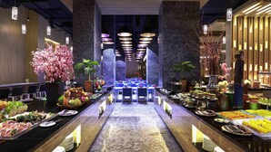 A modern hotel lobby with a central reception desk, seating areas, and decorative plants. - Grand Mercure Jakarta Kemayoran (Jakarta)