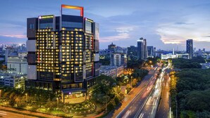 A modern hotel with a prominent Grand Mercure sign, surrounded by a well-lit urban environment and busy roads. - Grand Mercure Jakarta Kemayoran (Jakarta)