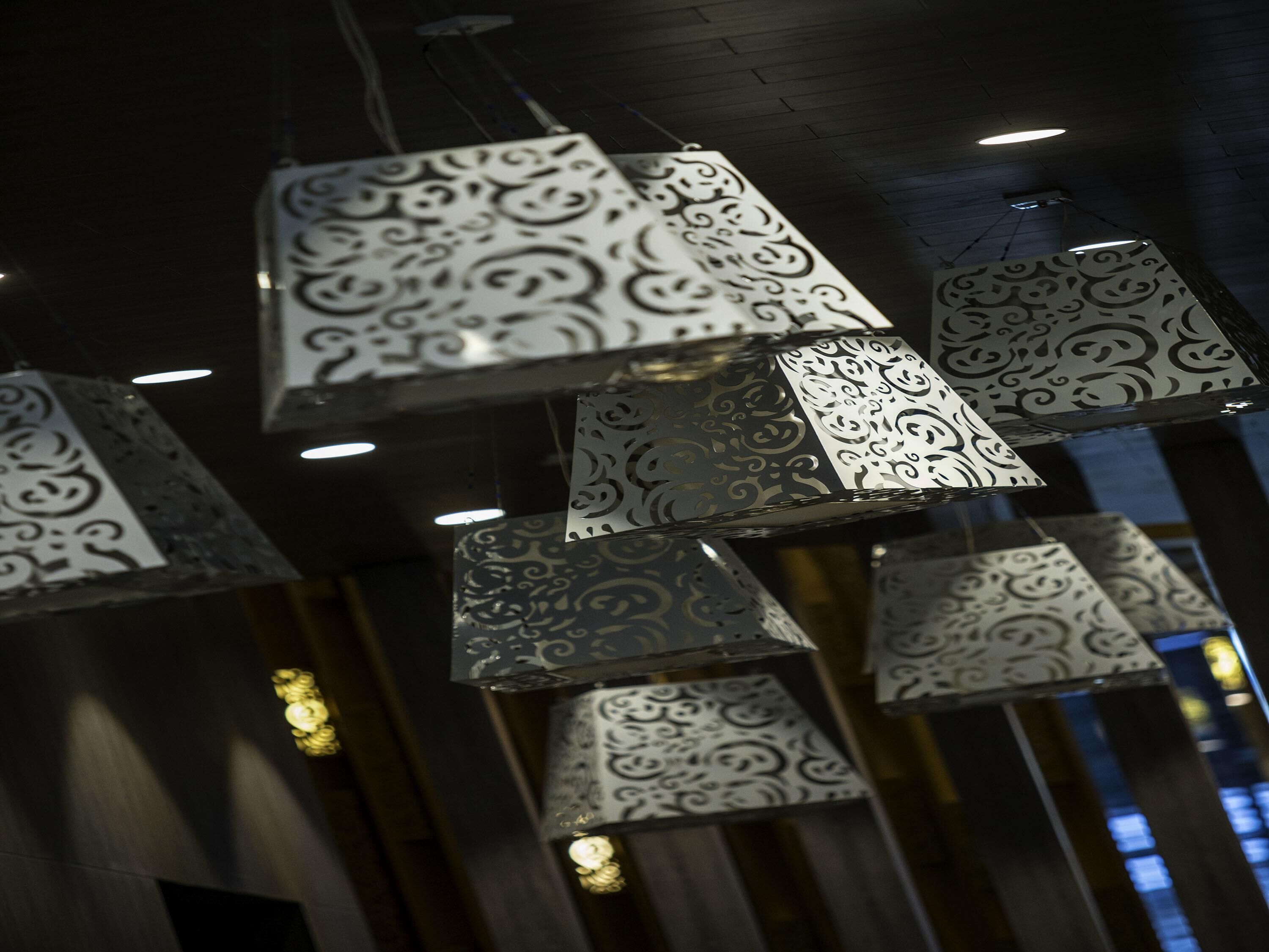 Hanging decorative light fixtures with intricate patterns.