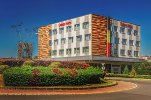 A modern hotel building with a prominent sign reading "Qubus Hotel". - Qubus Hotel Żory (Zory)