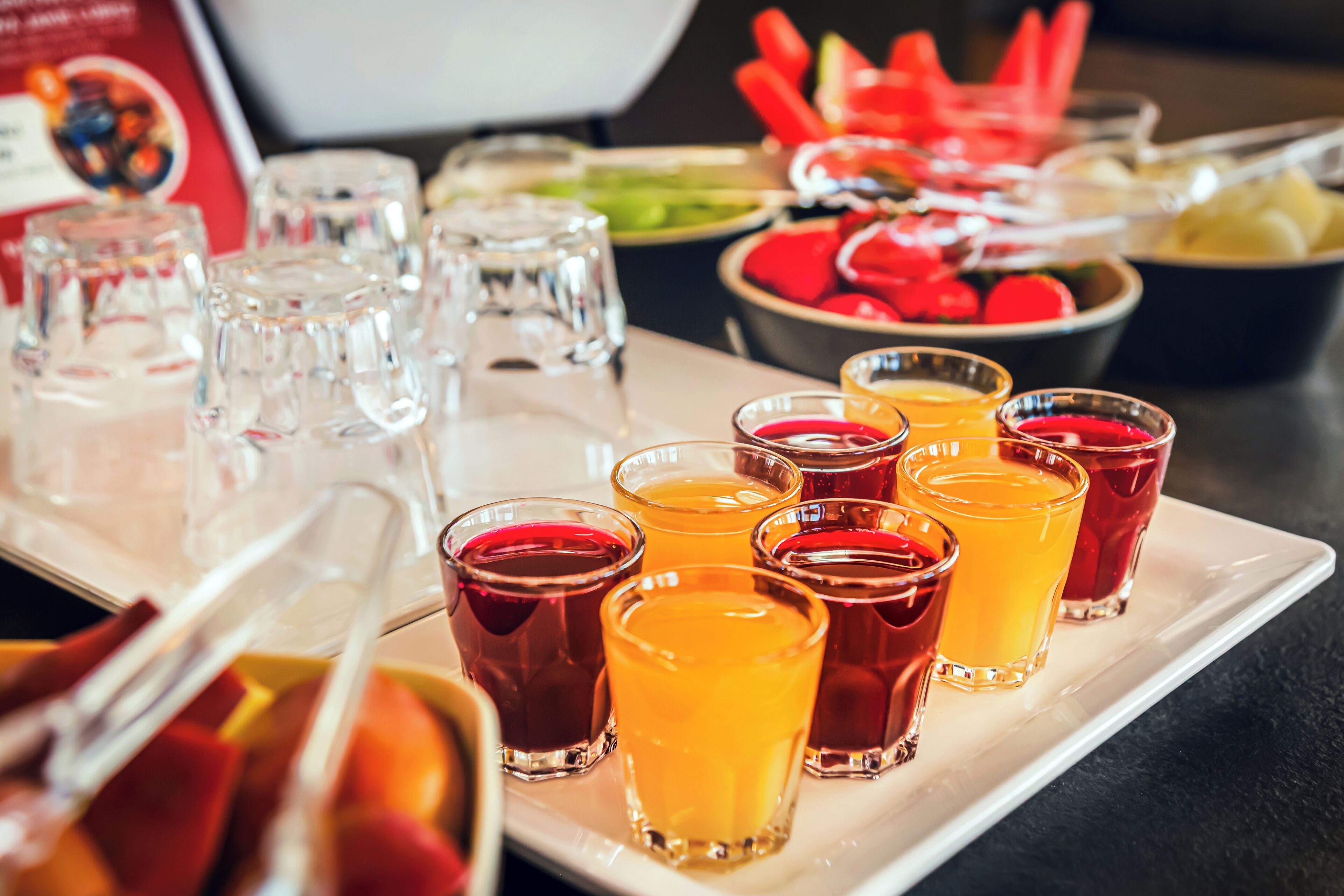 A buffet table with various food items and drinks.