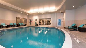 A swimming pool with lounge chairs and a glass door entrance. - Residence Inn Ann Arbor Downtown (Ann Arbor)