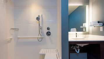 A modern bathroom with a shower, a toilet, and a sink.