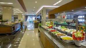 A buffet with various food options and a view of the dining area in the background. - Side Sunport Hotel & Spa - All Inclusive (Manavgat)