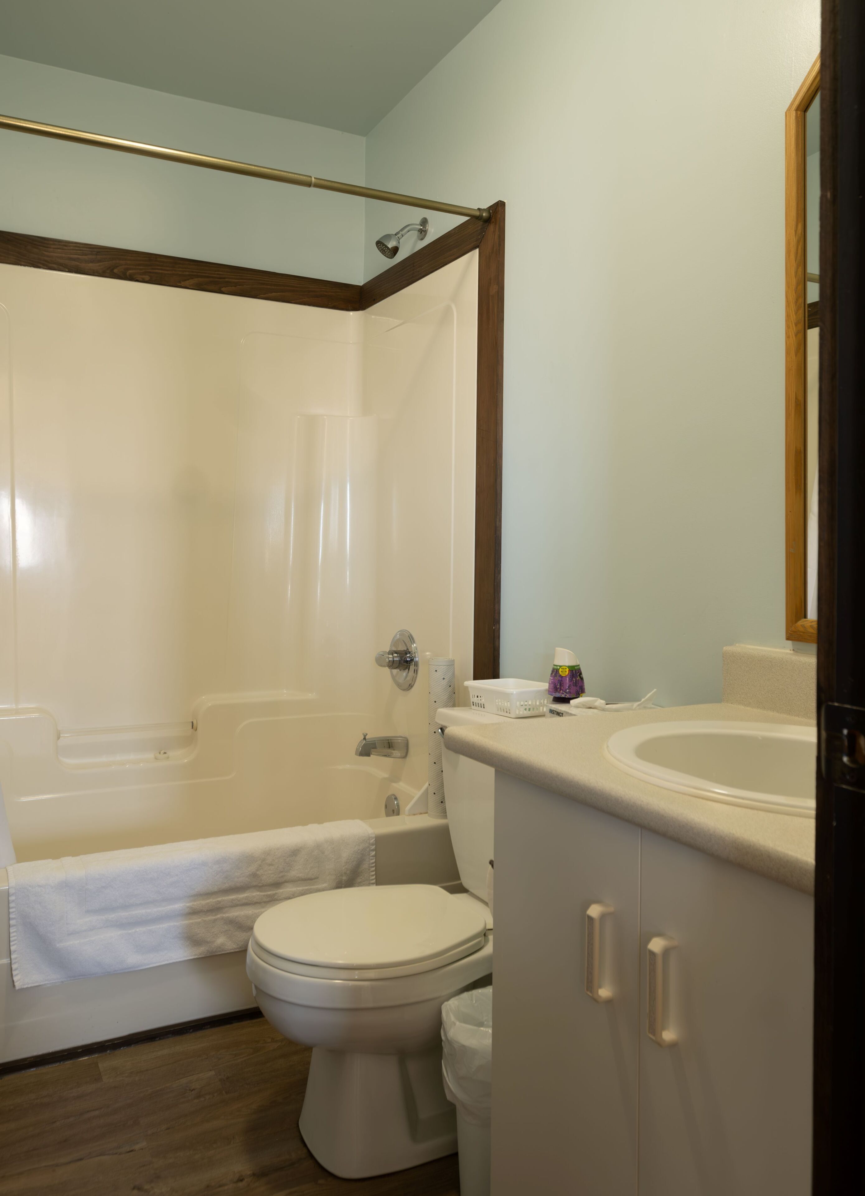 A bathroom with a bathtub, toilet, and sink.