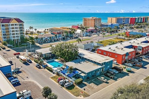 A coastal hotel with multiple buildings, a swimming pool, and a parking lot. - Malibu Resort Motel (North Redington Beach)