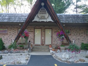A Red Moose Lodge with a brick facade, two doors, and flower arrangements in front. - Red Moose Lodge (Baldwin)