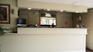A reception desk with a television, a framed picture, and a sign for Days Inn. - Budget Inn of Jasper (Jasper)
