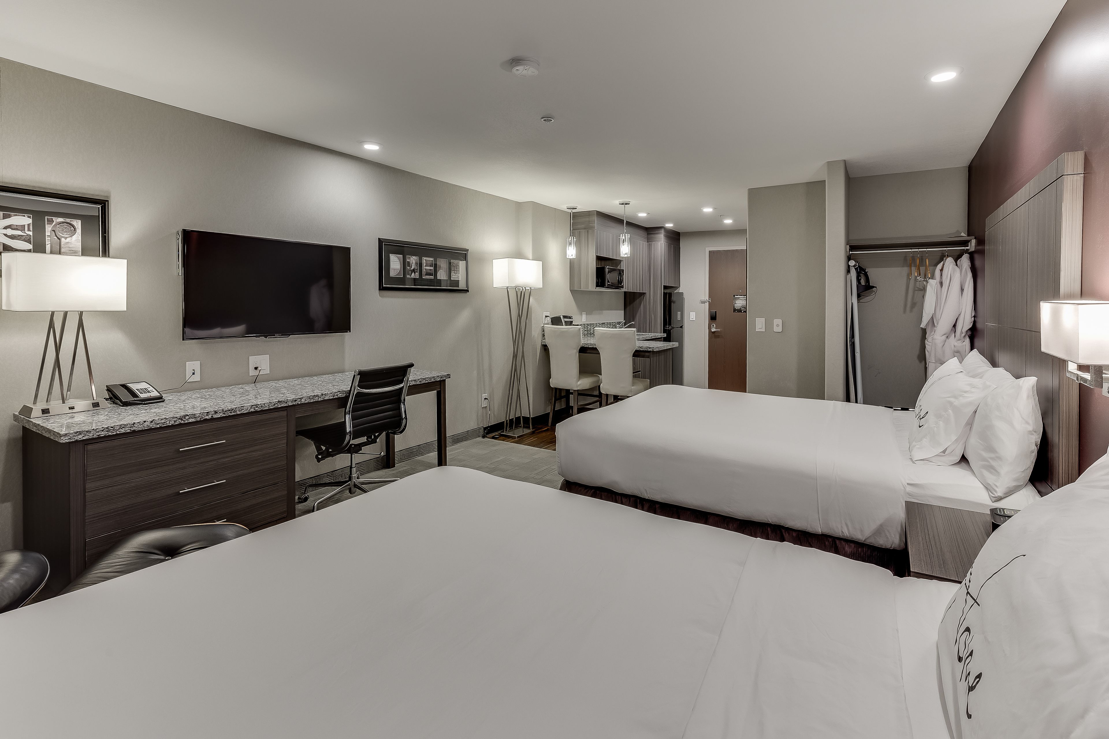 standard suite, 2 queen beds, kitchenette | 1 bedroom, premium bedding, desk, laptop workspace