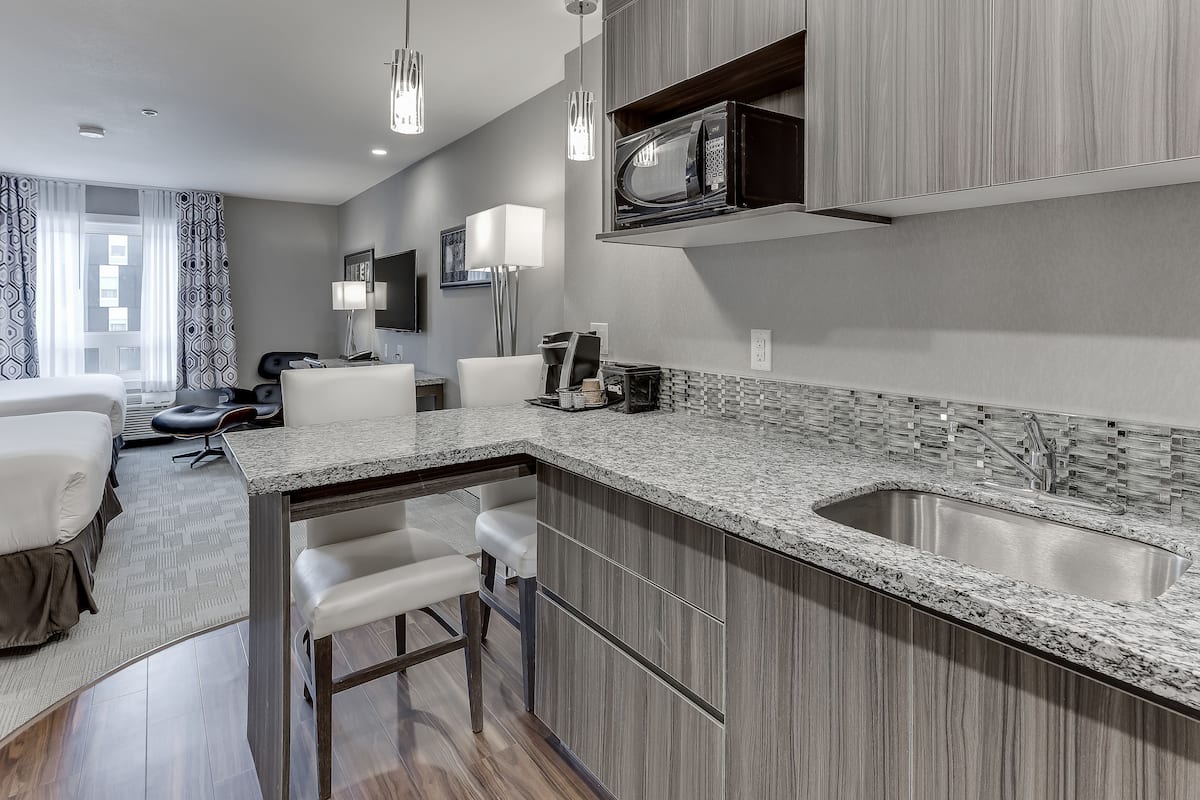 standard suite, 2 queen beds, kitchenette | 1 bedroom, premium bedding, desk, laptop workspace