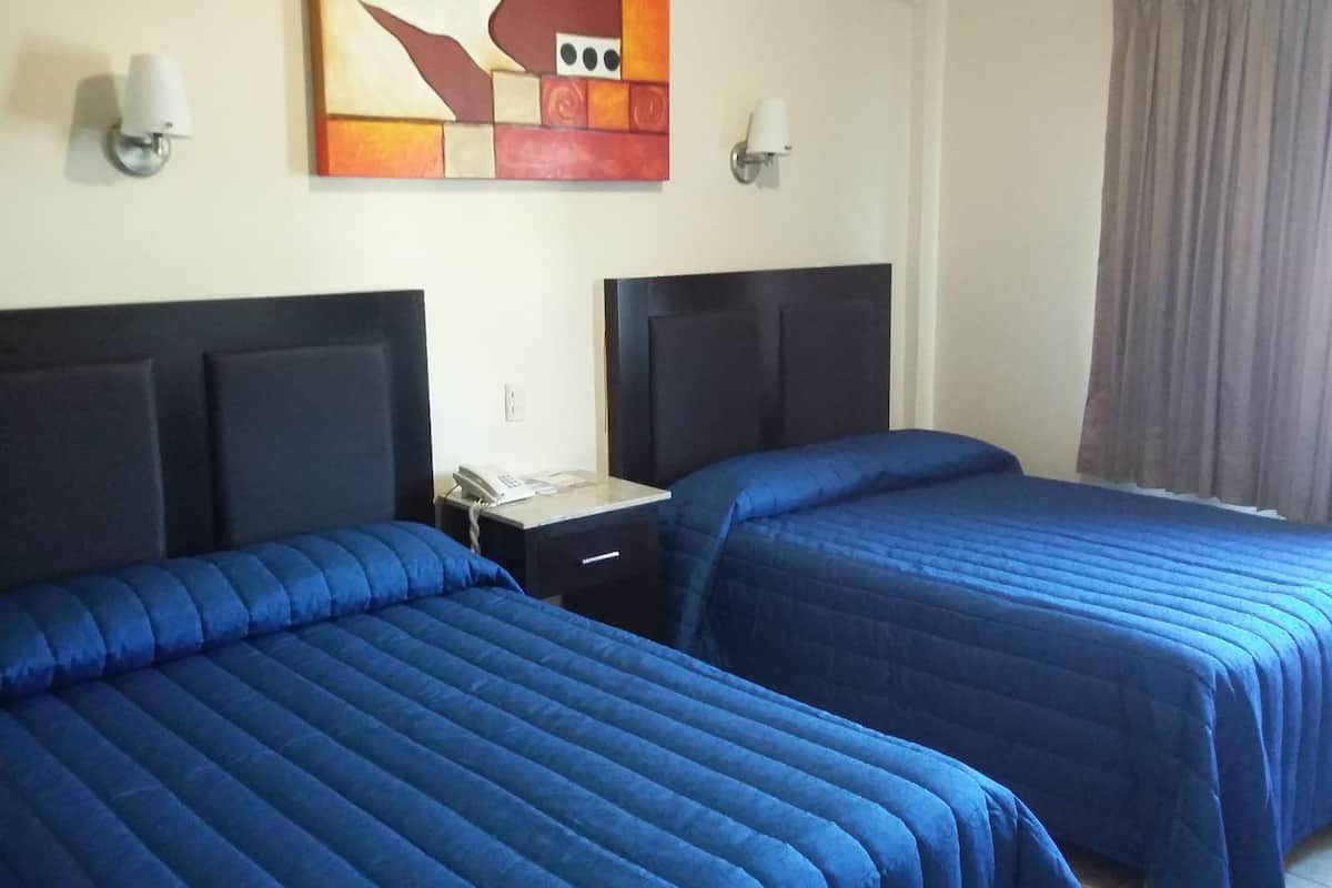 A hotel room with two beds, a nightstand, a phone, and a painting on the wall.