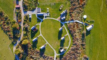 An aerial view of a property with a central circular lawn, surrounded by buildings and pathways.