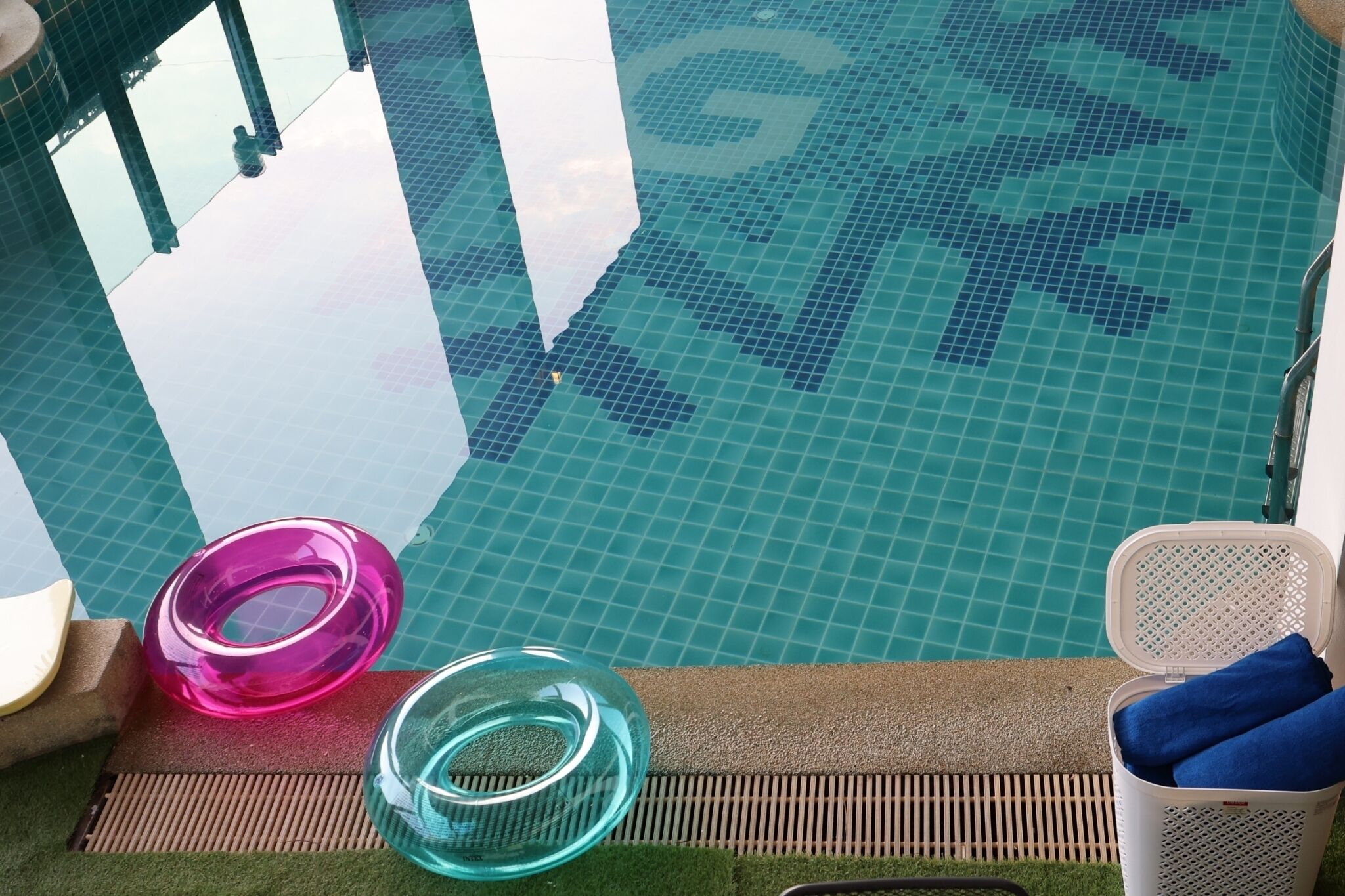 A swimming pool with a tiled floor and a drain cover.