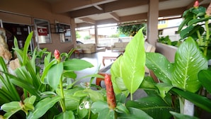 A spacious indoor area with a seating area and a view of the outside. - DMa Hotel (Khon Kaen)