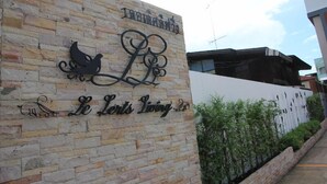 Una pared de piedra con un letrero que dice "Le Lerts Living".