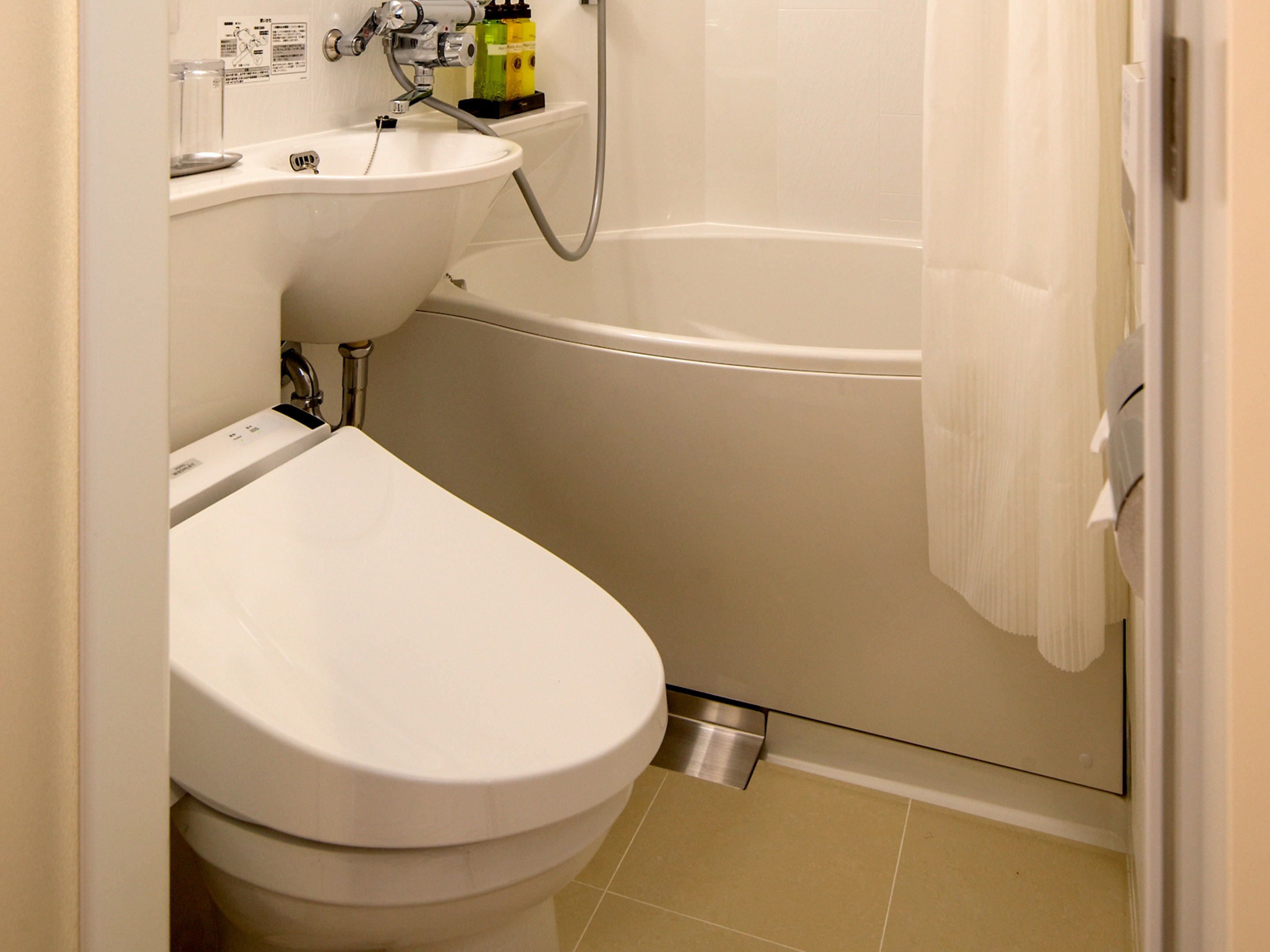 designer toiletries, hair dryer, slippers, bidet