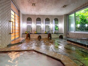 A traditional Japanese onsen with multiple hot spring baths, tiled walls, and a large window providing a view of greenery outside. - TKP Hotel & Resort Lectore Hakone Gora (Hakone)