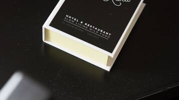 A black brochure for Royal Ruka Hotel & Restaurant, featuring a modern design and contact information.