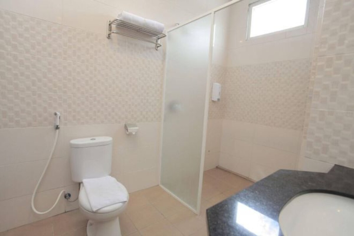 Un baño con inodoro, ducha y lavamanos.