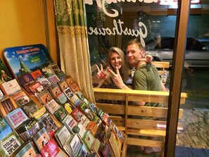 A bookstore with a variety of travel and adventure books displayed on shelves and tables. - The Living Place 2 - Hostel (Chiang Mai)