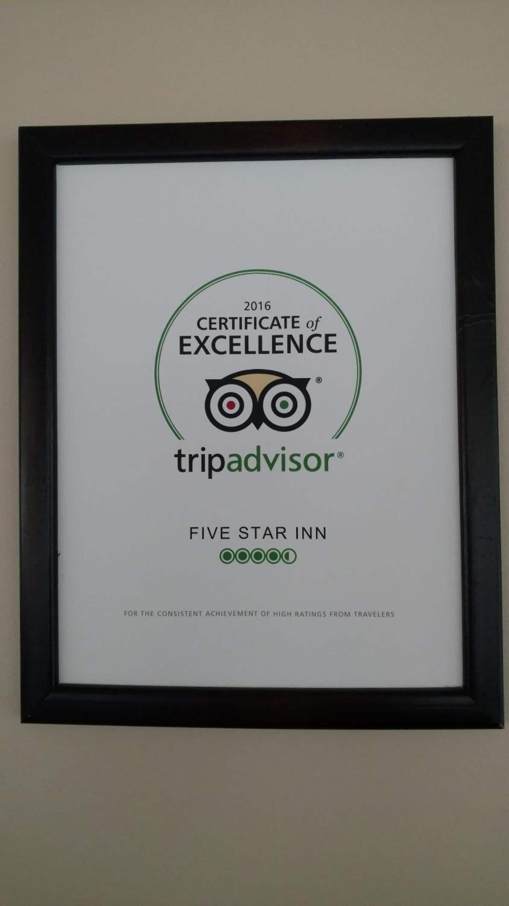 A framed certificate of excellence for a Five Star Inn, awarded by TripAdvisor in 2016.