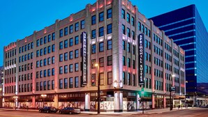 A multi-story hotel with a classic architectural style, featuring large windows and a prominent signage for 'SPRING CHILL SUITES'. - SpringHill Suites by Marriott Milwaukee Downtown (Milwaukee)