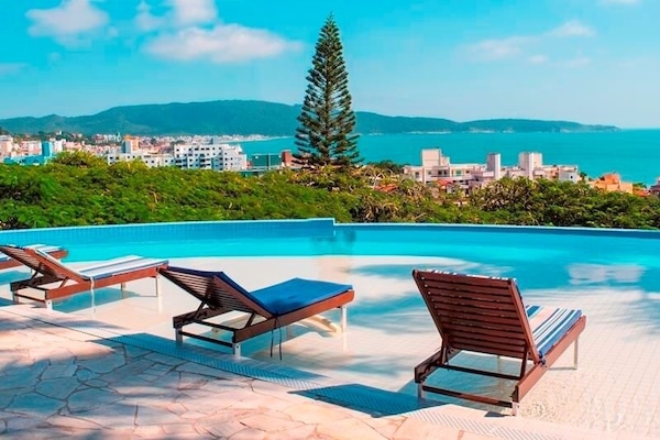 Outdoor pool, open 9:00 AM to 10:00 PM, pool umbrellas, pool loungers