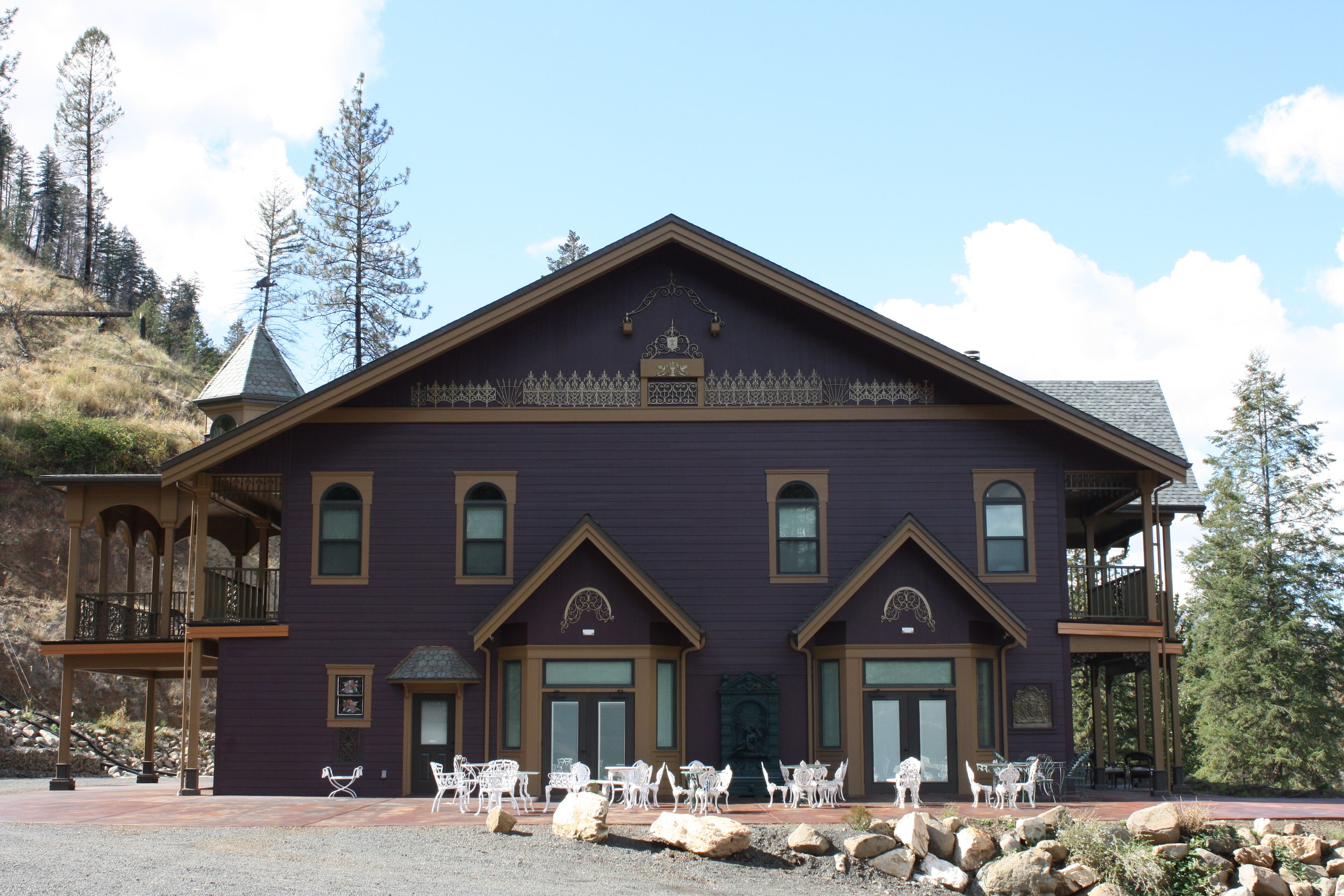 A large, two-story building with a prominent entrance and a balcony.