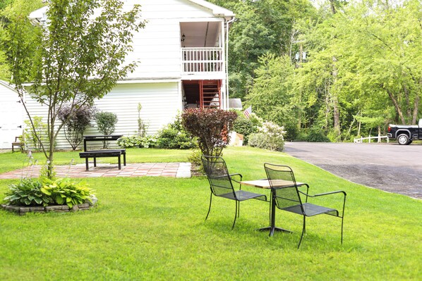 A house with a front porch, a small garden, and a paved driveway. - Chatham Travel Lodge (Old Chatham)
