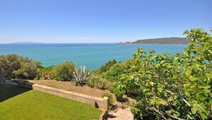 A coastal landscape with a clear view of the sea and distant hills. - Presidio (Orbetello)