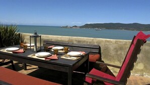 A table set for dining with a view of the sea and hills in the background. - Presidio (Orbetello)