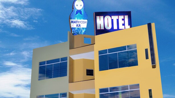 A hotel with a prominent sign reading "MATRYOSHKA HOTEL" and a large mascot figure. - Matryoshka (Ica)