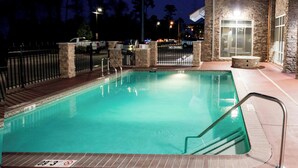A swimming pool with a stone wall and metal railing, surrounded by a brick walkway and a 'No Diving' sign. - Residence Inn Lake Charles (Lake Charles)