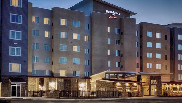 A multi-story hotel with a modern design, featuring a prominent entrance with a covered area and a sign that reads "Residence Inn Marriott". - Residence Inn Lake Charles (Lake Charles)