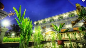 A well-lit hotel with a large pool, surrounded by lush greenery and a night sky. - Galaxy Angkor Boutique Hotel (Siem Reap)