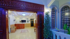 A spacious lobby with a polished floor, a reception desk, and a large potted plant. - Serkirin Mary Angkor Villa (Siem Reap)