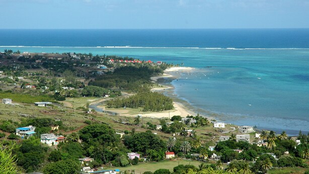 A coastal town with a beach, houses, and a clear view of the ocean. - Reve des Iles (Rodrigues Island)
