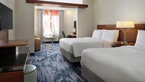 A hotel room with two beds, a desk, a chair, a TV, and a window with curtains. - Fairfield Inn & Suites by Marriott Niagara Falls (Niagara Falls)