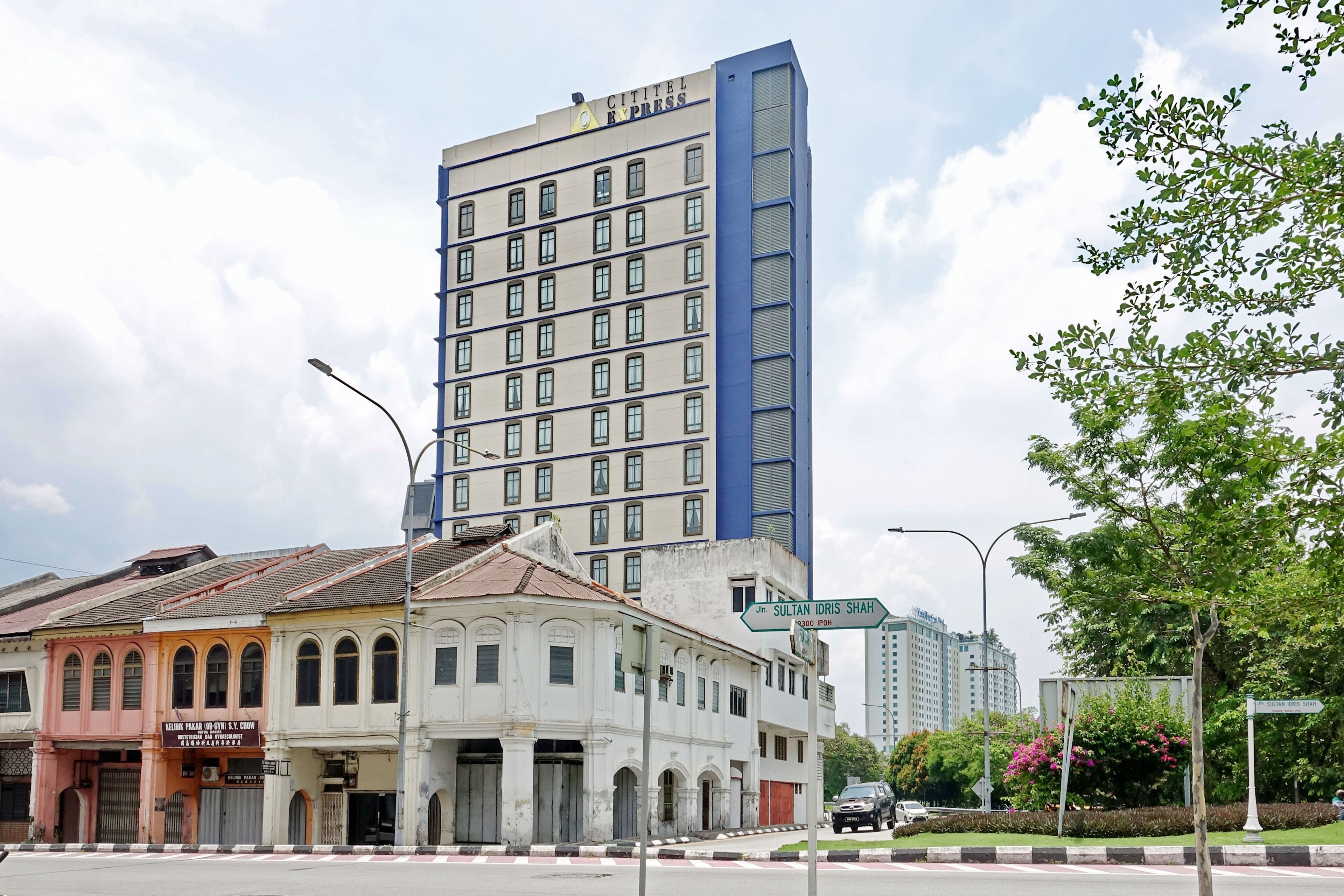A hotel with a modern design, featuring a prominent blue and white color scheme, multiple floors, and a large window facade.